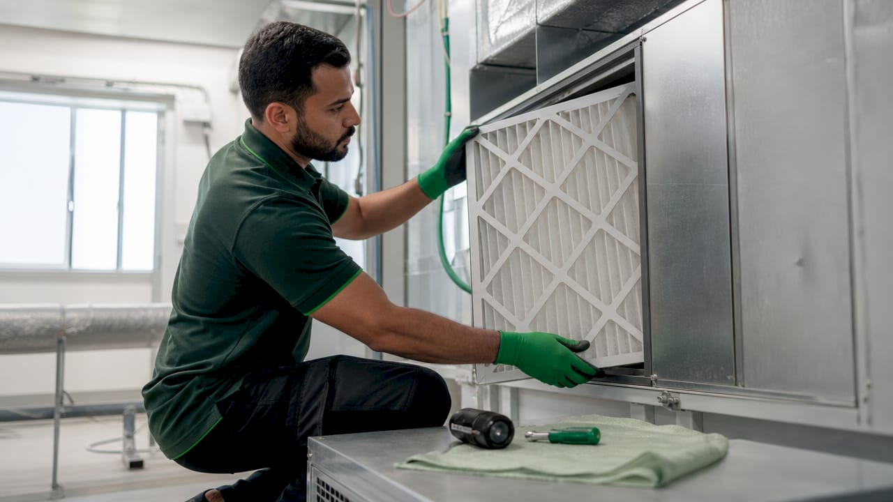 Technician inserting clean air filter