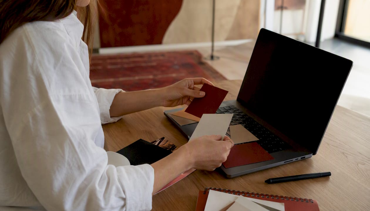 Hands designing media kit templates on tablet