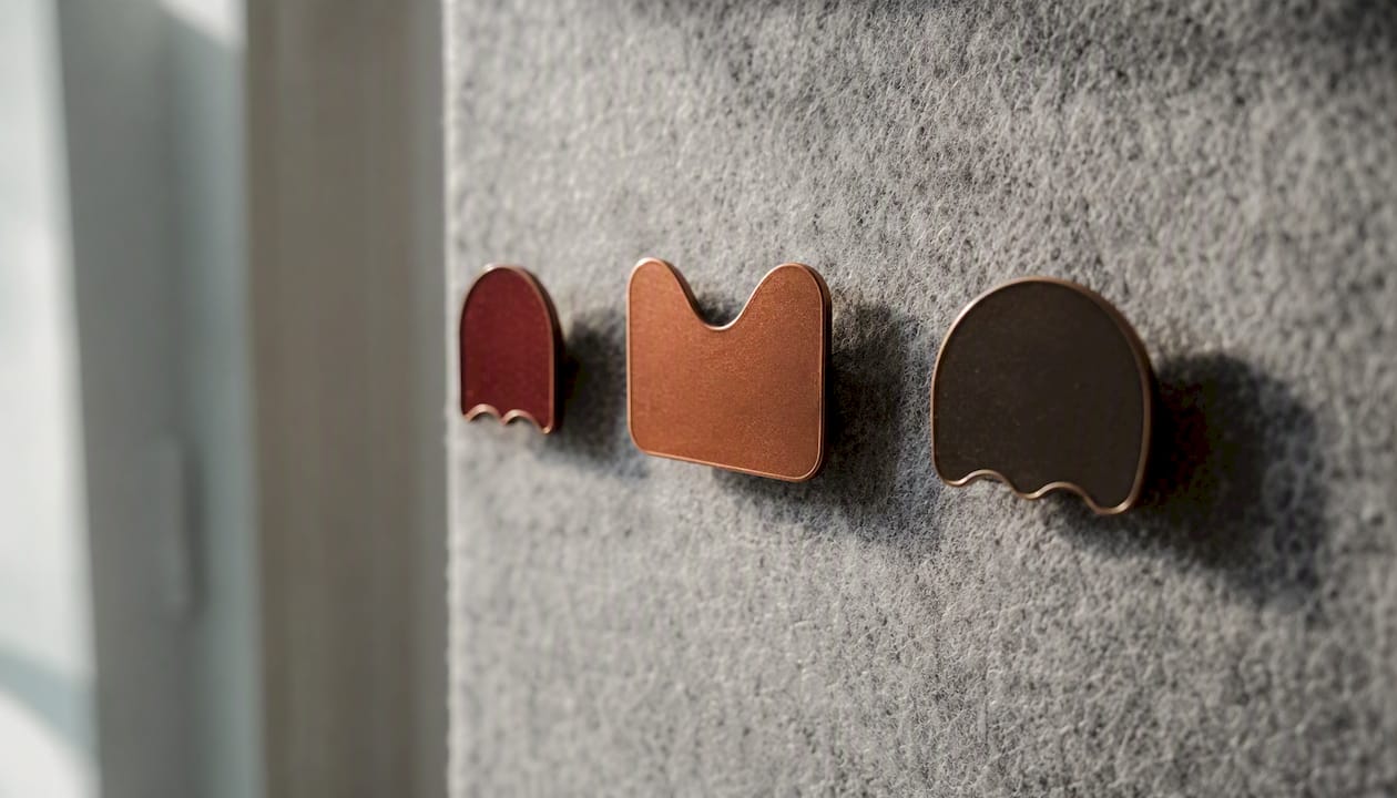 Three exclusive tier membership badges on corkboard