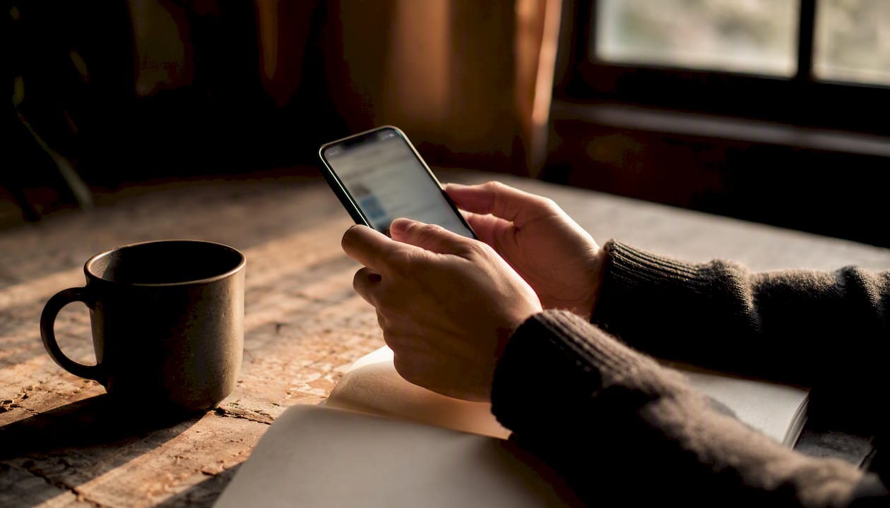 Hands holding smartphone in private community space