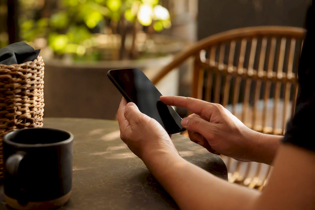 Hands holding smartphone setting up affiliate account