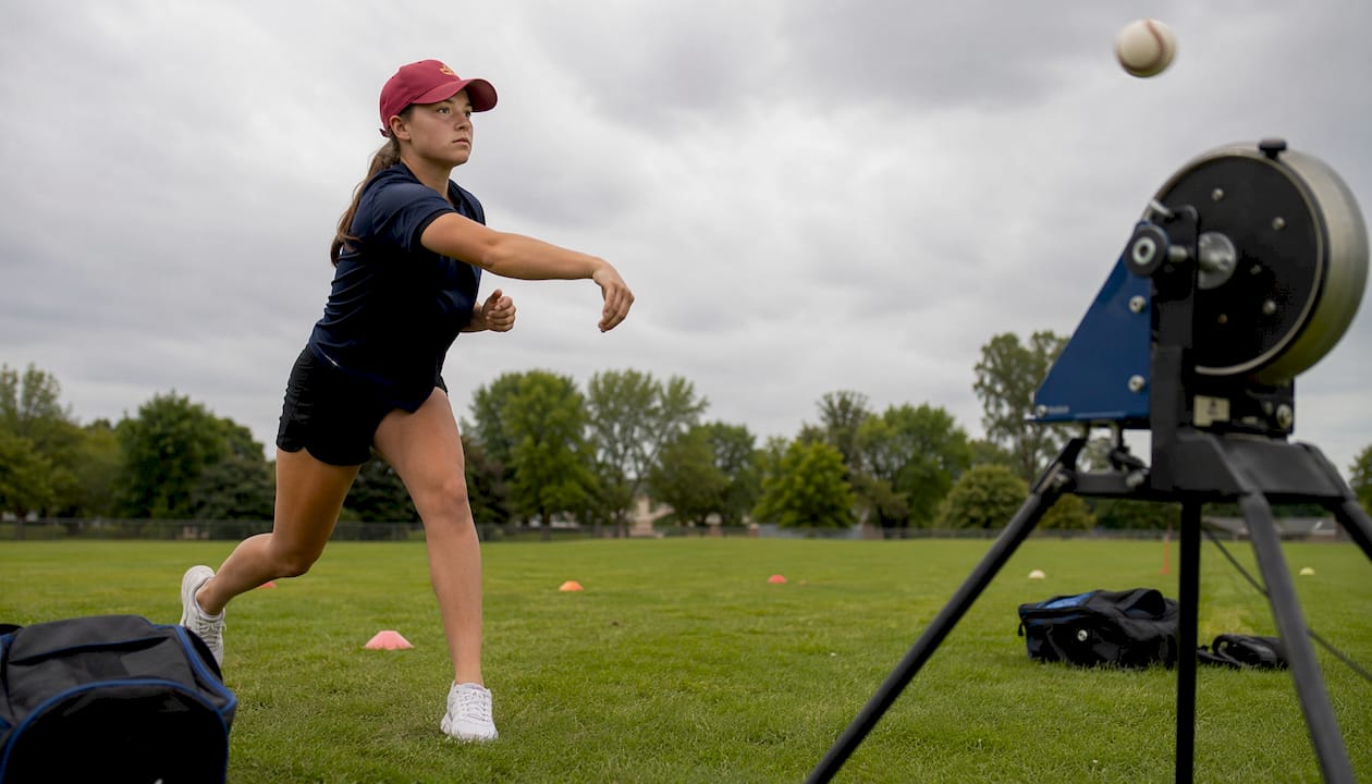 Female pitcher training with advanced pitching simulator
