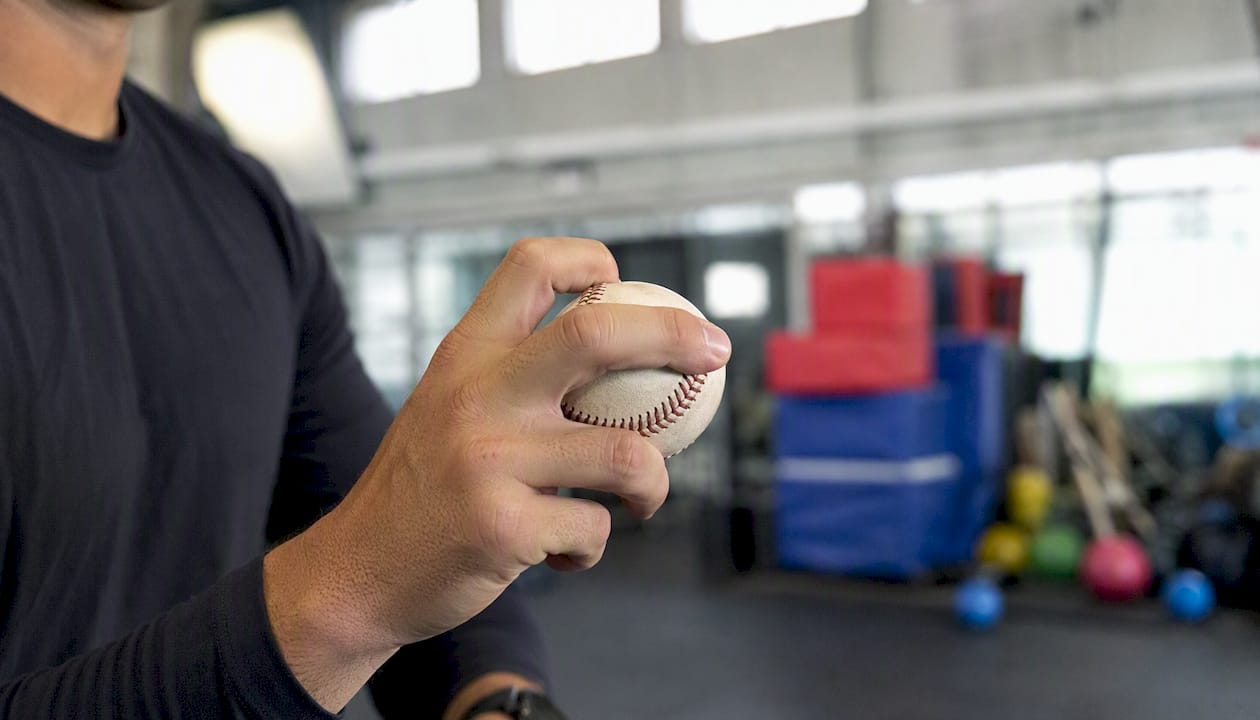 Pitcher adjusting slider grip close-up