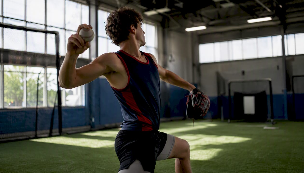 Pitcher practicing pitch tunneling indoors