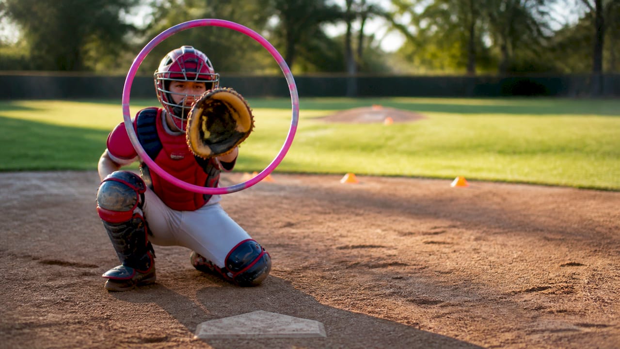 Catcher holding target circle for pitching drill