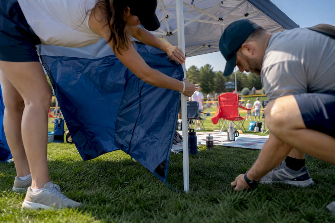 Parents setting up baseball sideline tent
