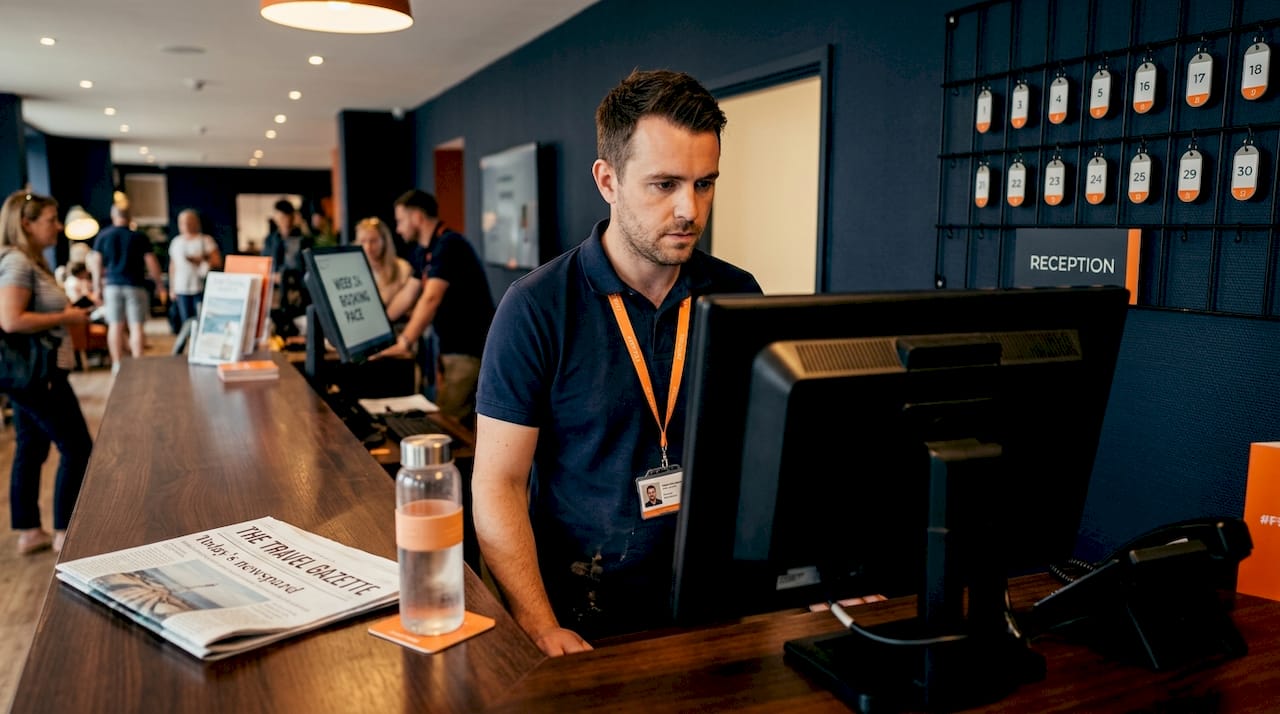Onsite manager reviews booking pace at lobby counter
