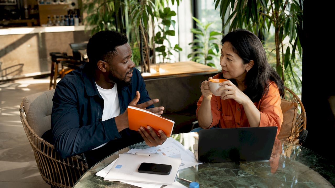 Two managers discussing rental pricing