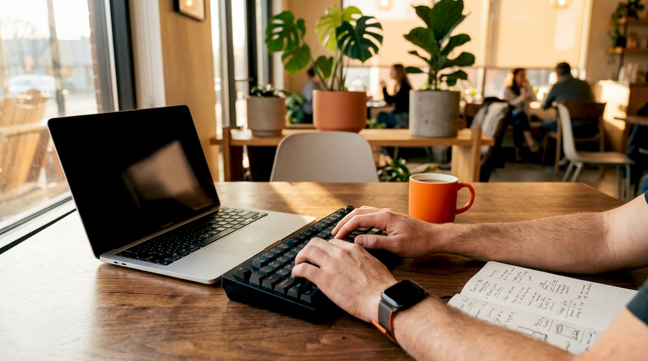 Hands typing on keyboard for data syncing