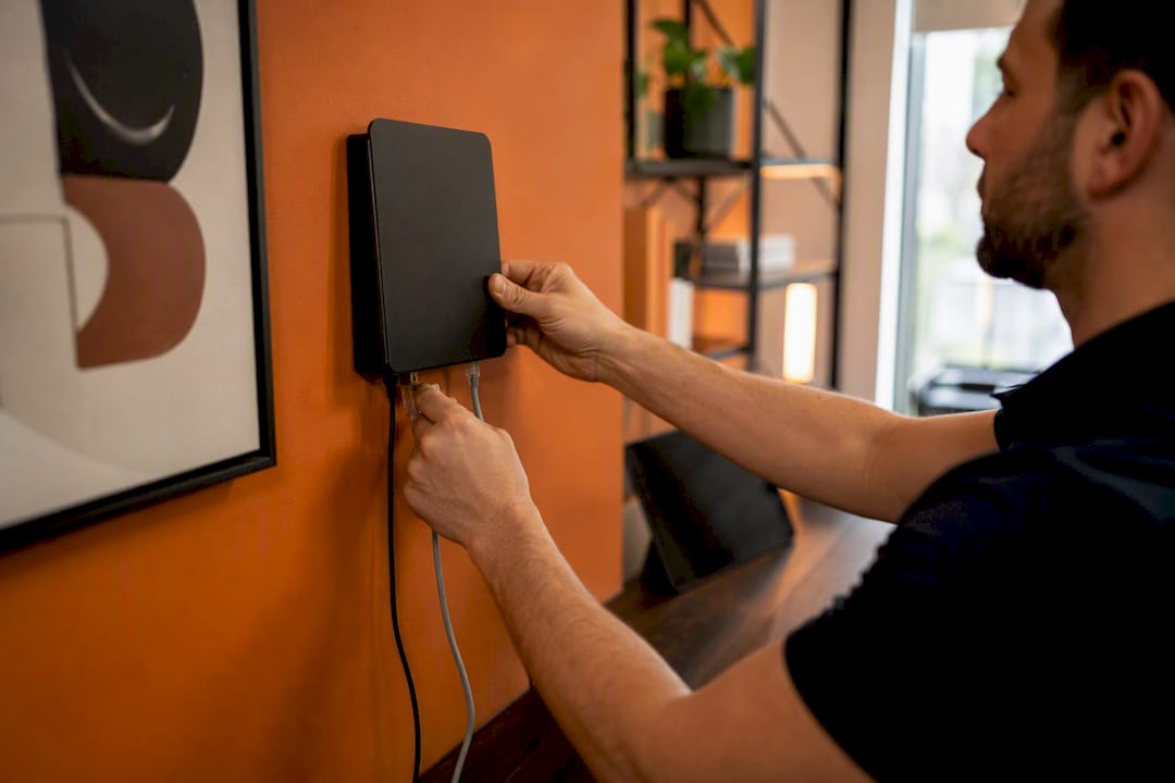 Hands plugging network cable router