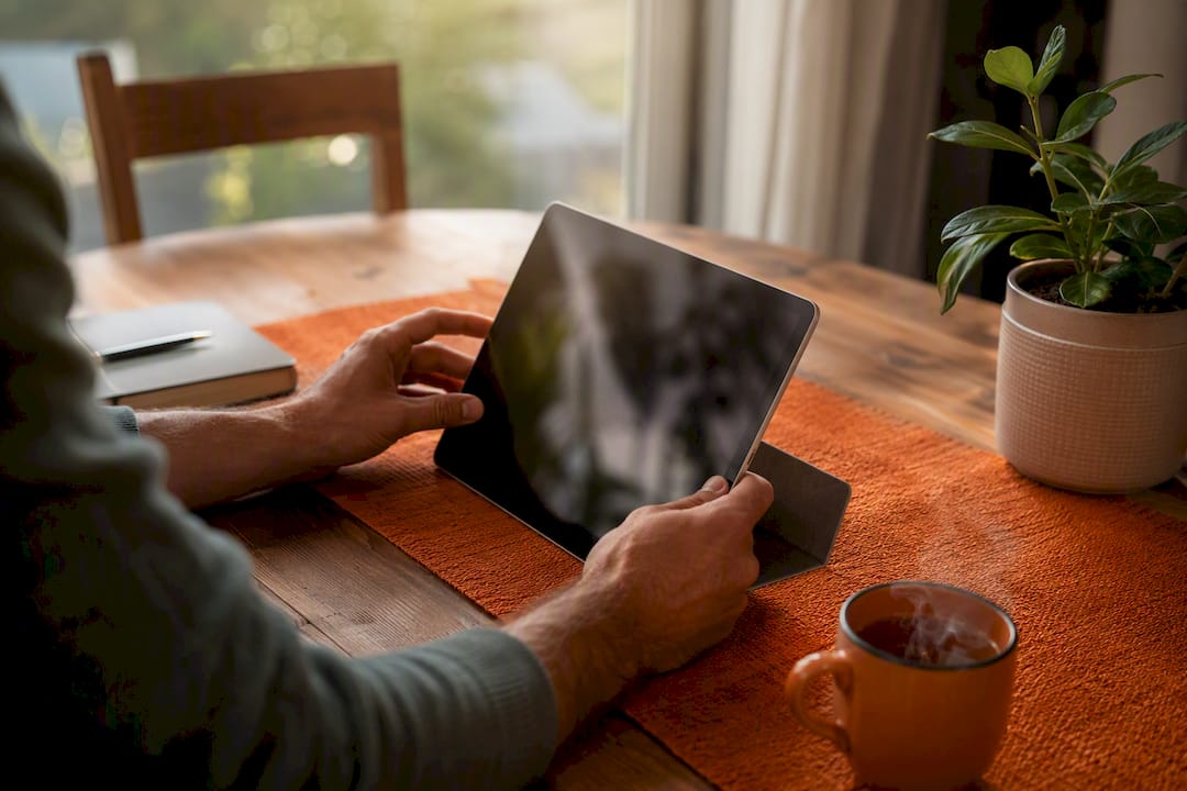 Hands adjusting digital calendar on tablet