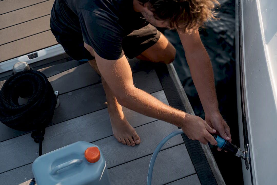 Renter connecting freshwater hose at dock