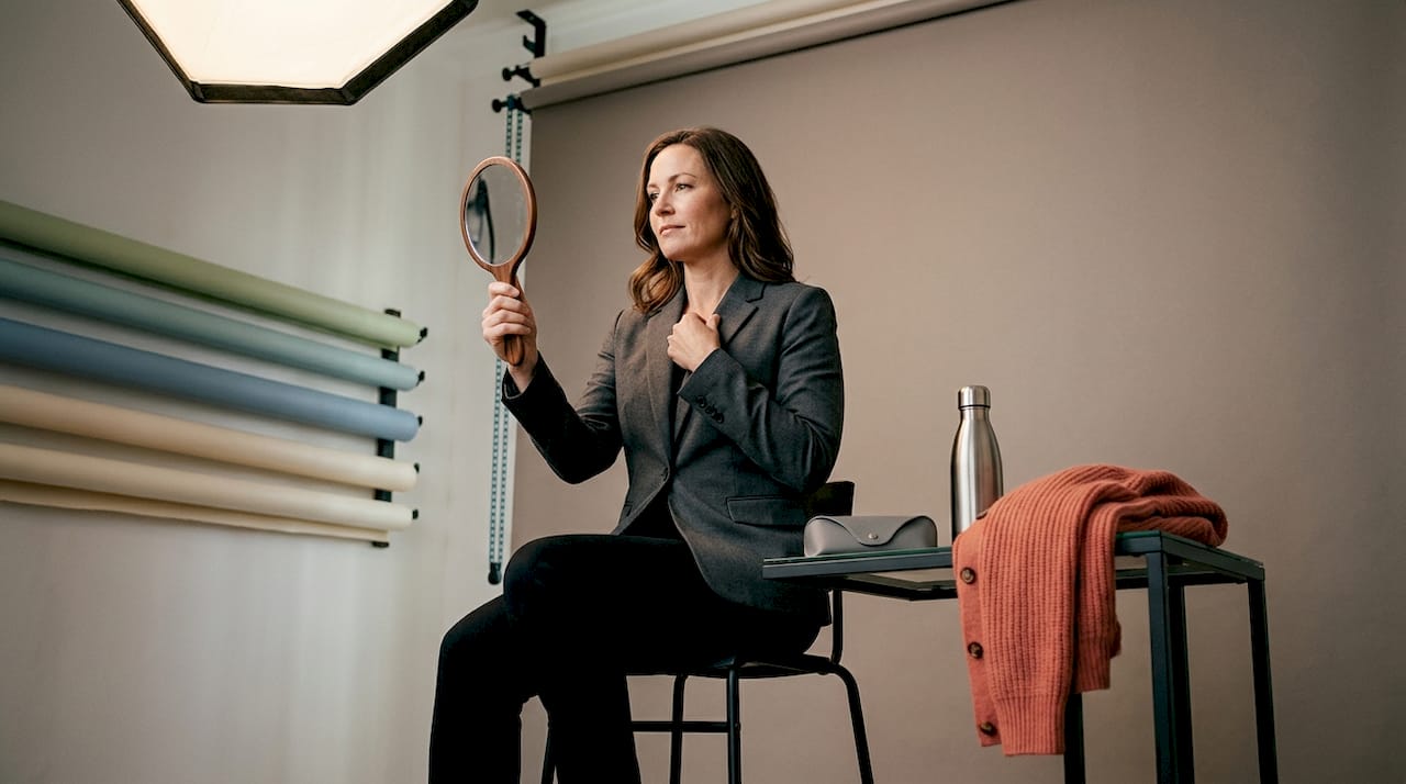 Posing for headshot in neutral gray studio