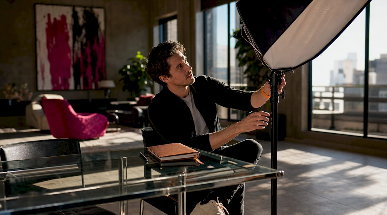 Man adjusting lighting for headshot photoshoot