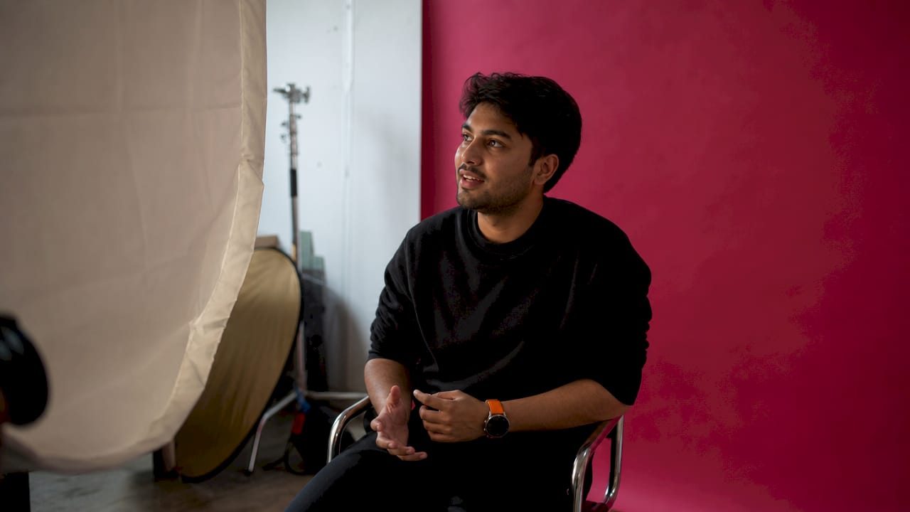 Studio headshot lighting setup with subject seated