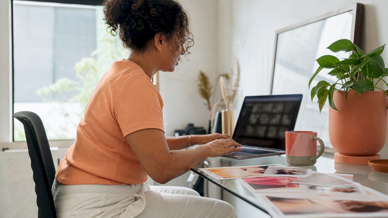 Person editing branding photos at home desk