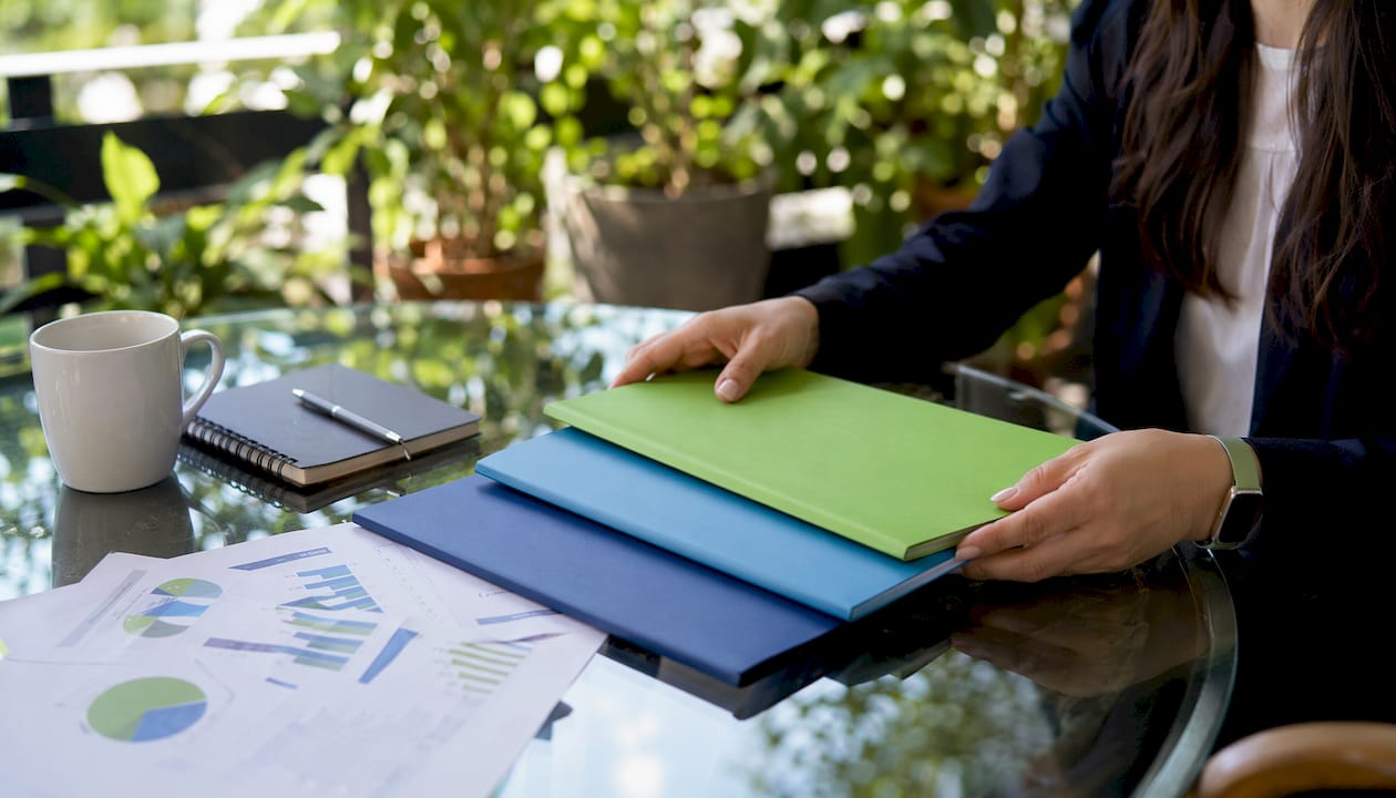 Hands holding folders of water damage categories