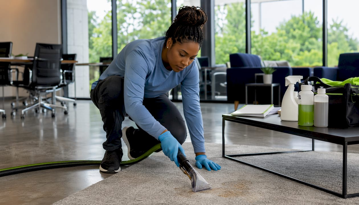 Technician treating polyester carpet stains