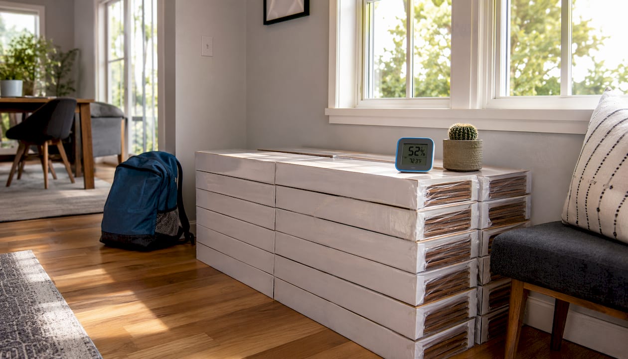 Boxes of hardwood planks acclimating in room