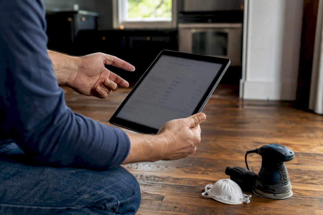 Contractor showing broken down flooring estimate on tablet