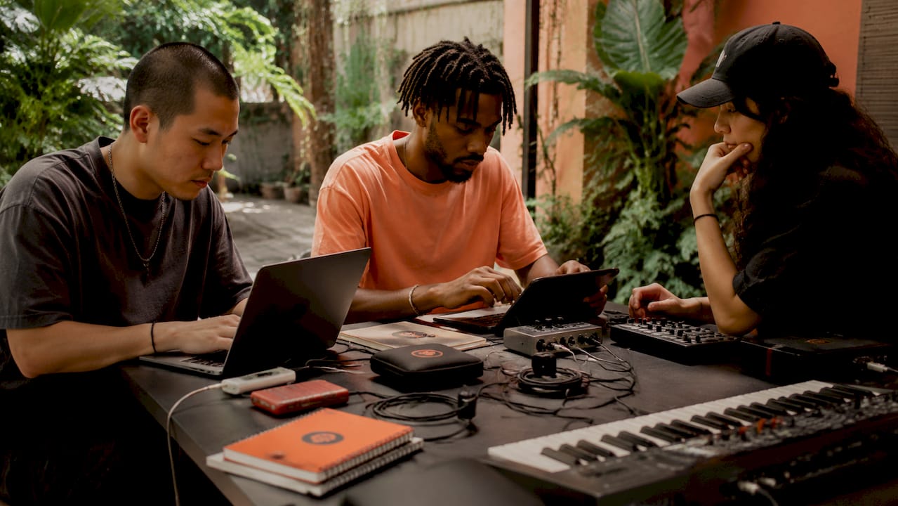 Group collaborating on cross-DAW music production
