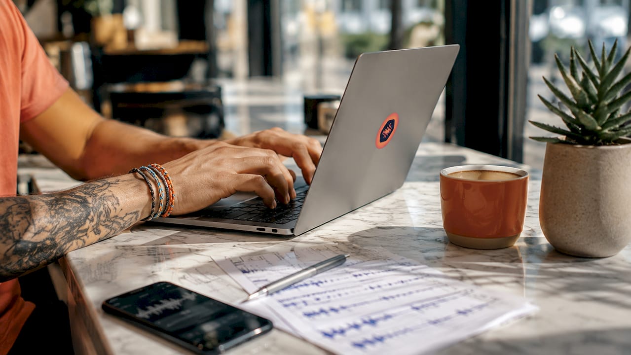 Hands typing on laptop sharing WAV files