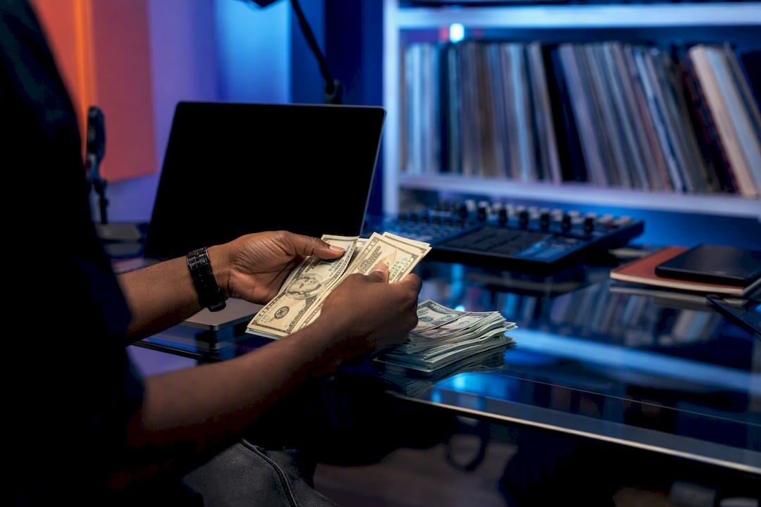 Hands placing deposit envelope in music studio