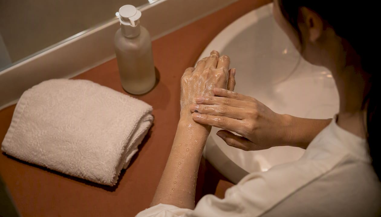 Hands massaging oil cleanser at night