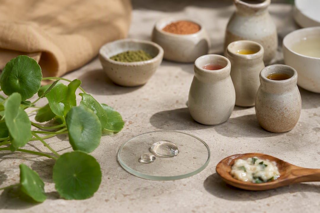 Botanical skincare ingredients on terracotta surface