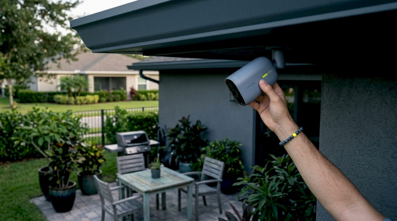 Homeowner adjusts outdoor security camera