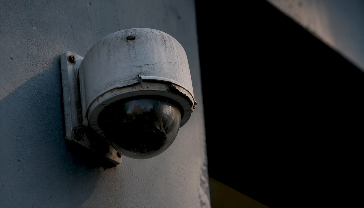 Sun-damaged outdoor security camera housing close-up