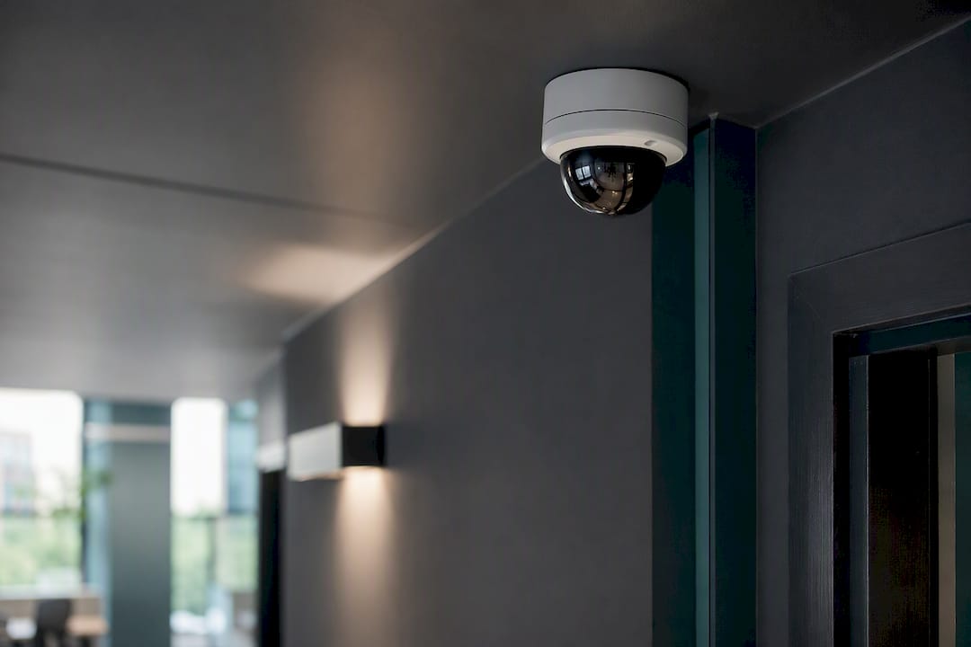 Dome camera mounted high in hallway corner