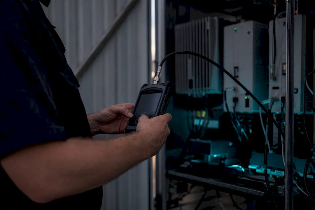 Hands adjusting RF meter during grid test