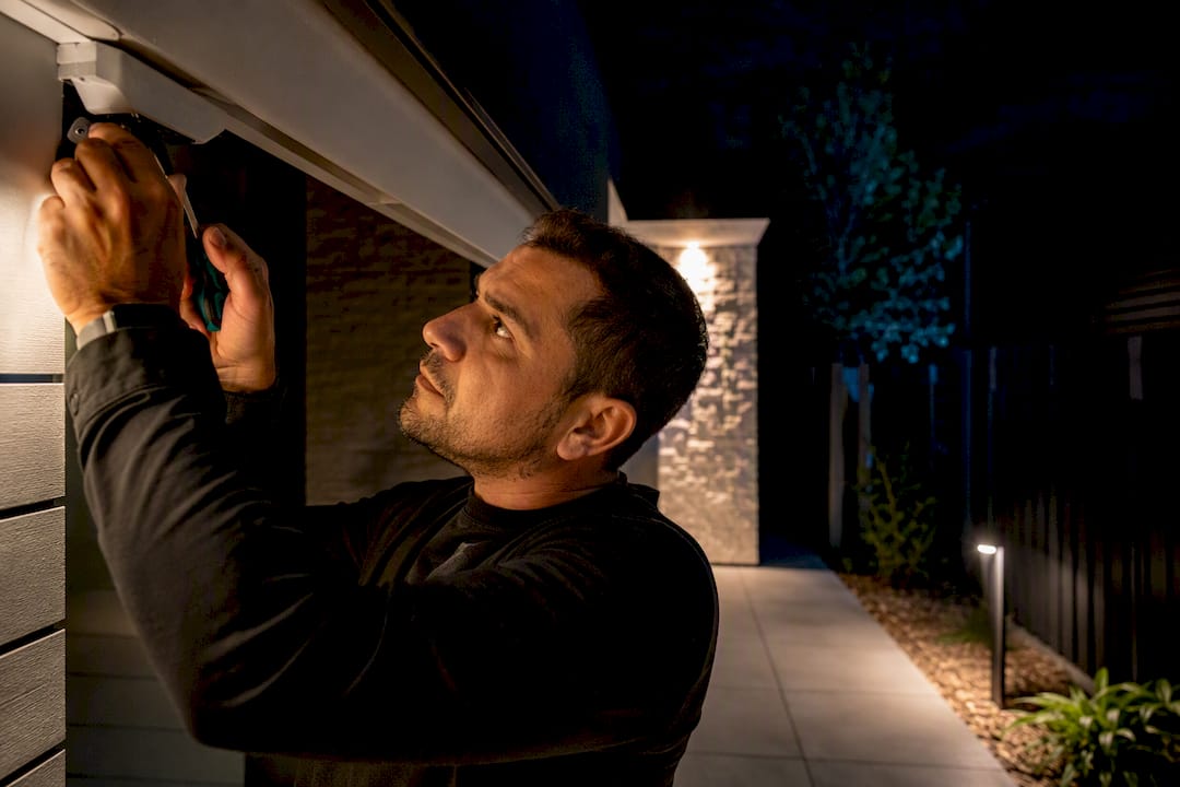 Installer adjusting camera near warm entry lighting