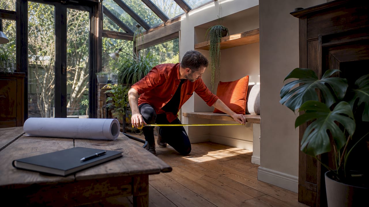 Hands measuring space during furniture consultation