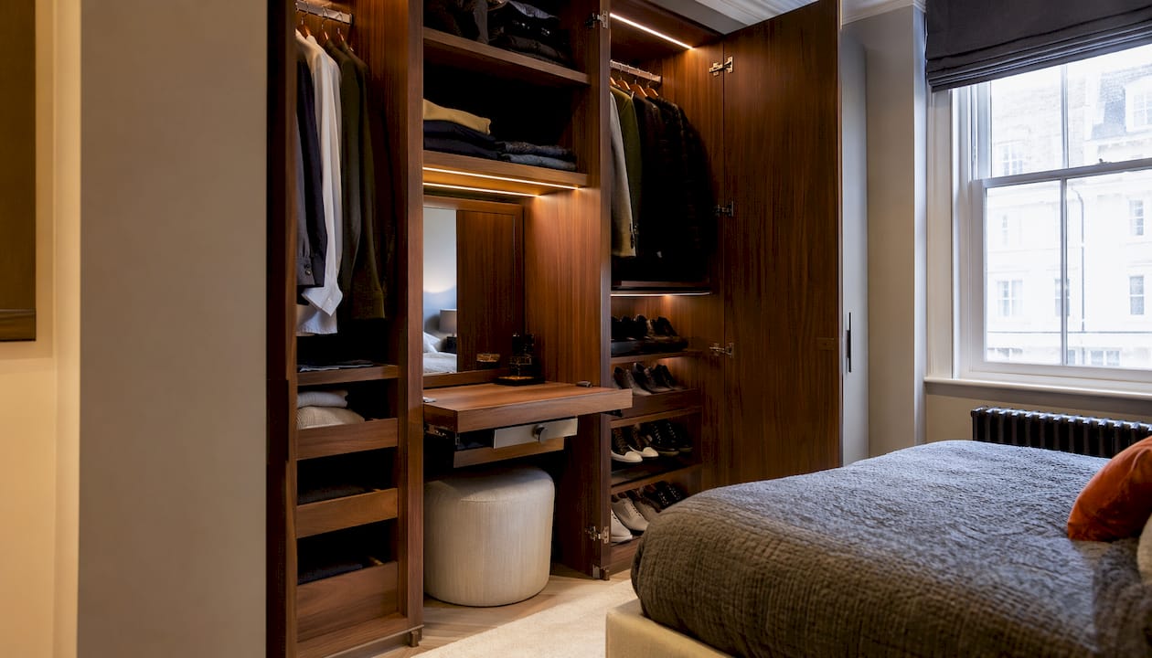 Close-up of bespoke wardrobe interior with adjustable shelving and dressing table