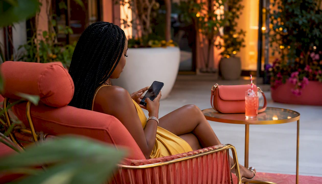 Hands scrolling braiding salon reviews on phone