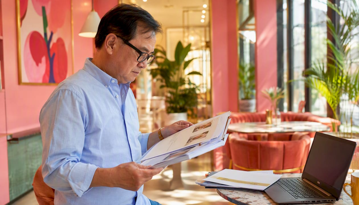 Man reading stylist review documents in salon