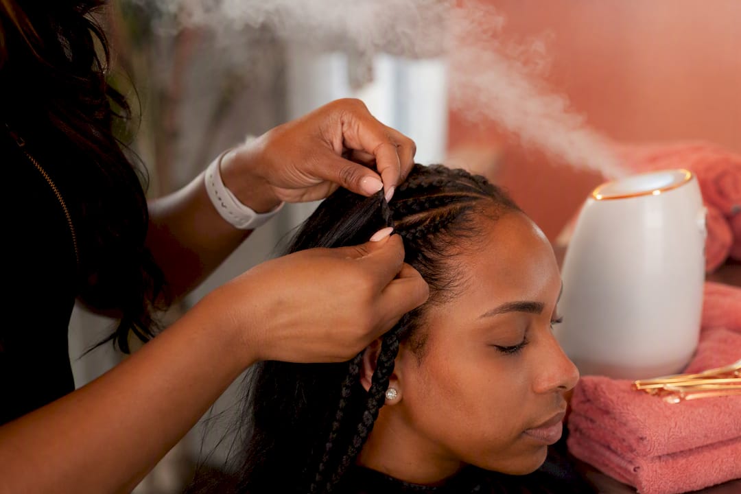 Hands checking braid tension with steam