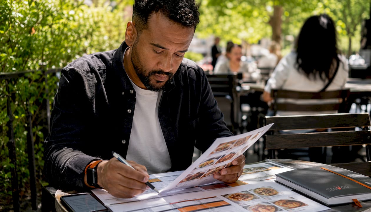 Catering manager reviewing menu and staffing plan