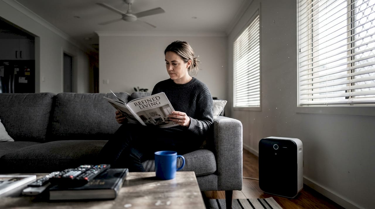 Air purifier and woman in lived-in living room