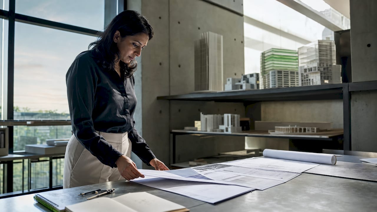 Architect reviewing printed risk documents