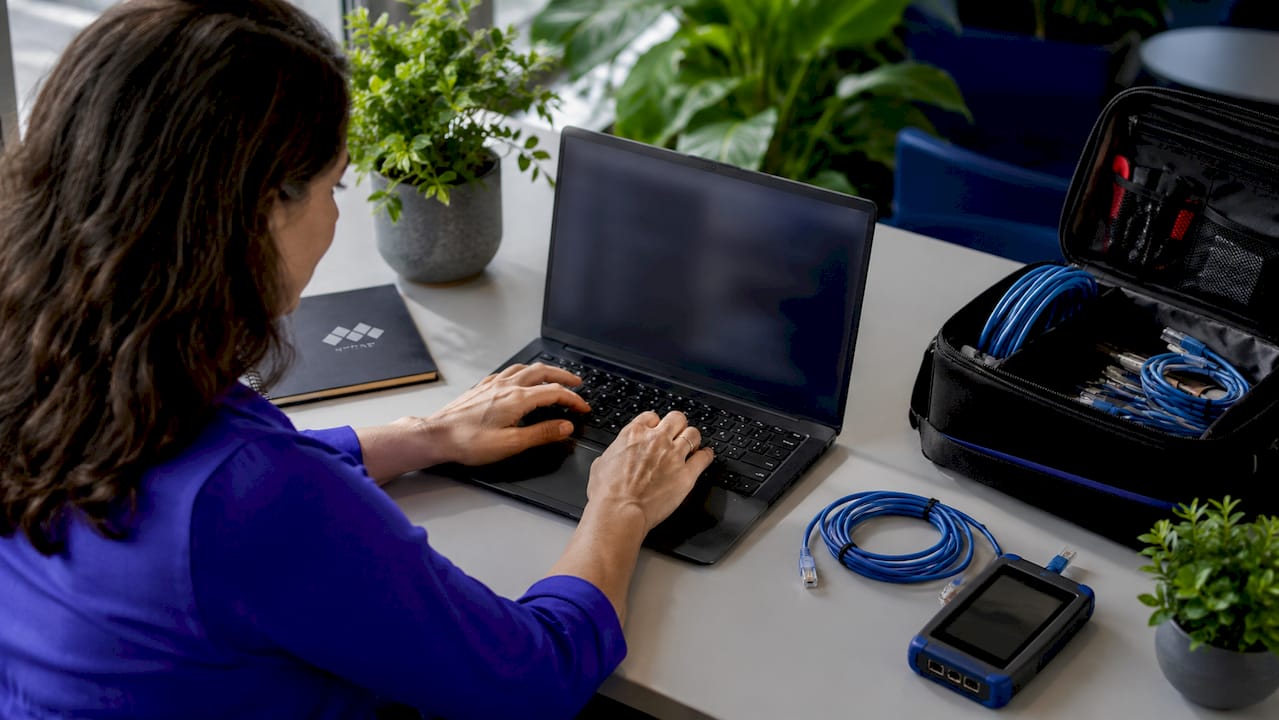 IT specialist typing diagnostics on laptop
