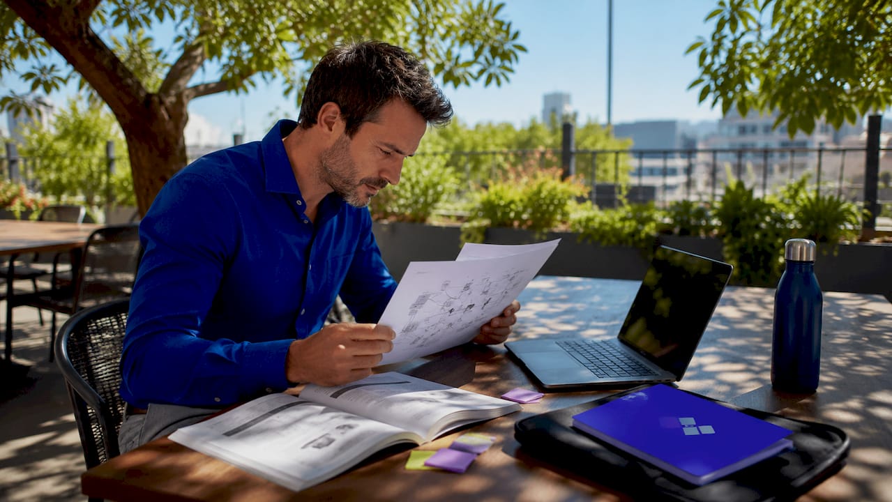 IT specialist typing network data on laptop