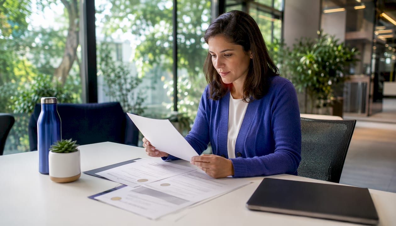 Network admin reviewing certifications at desk
