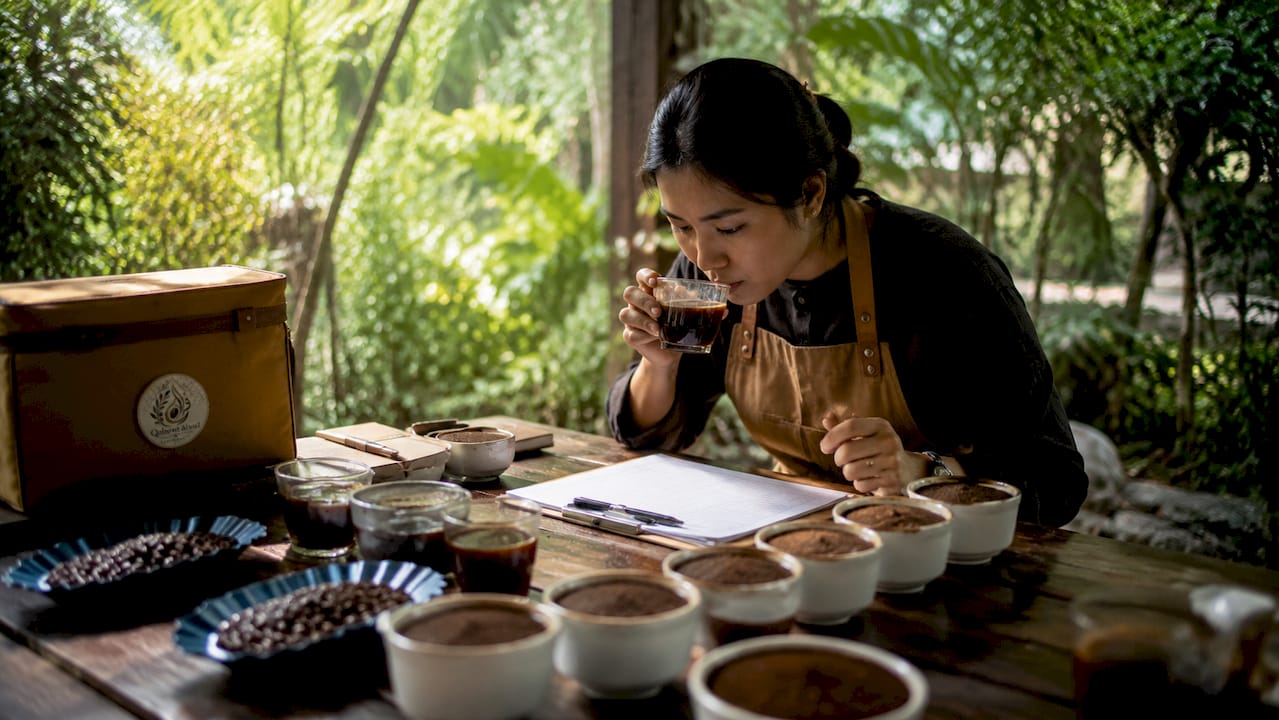 Woman performing coffee sensory evaluation