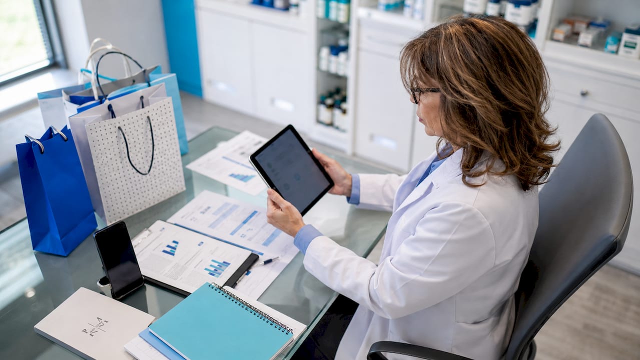 Pharmacist using tablet for marketing strategies