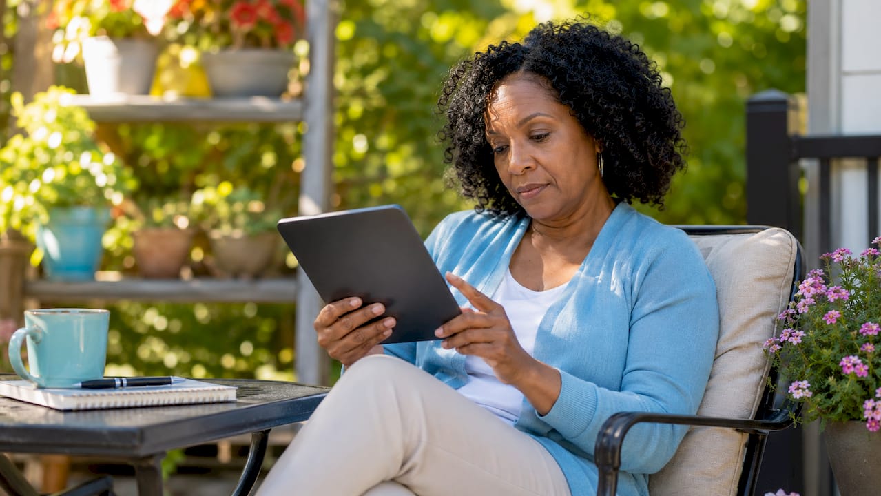 Woman reviewing healthcare online reviews on tablet