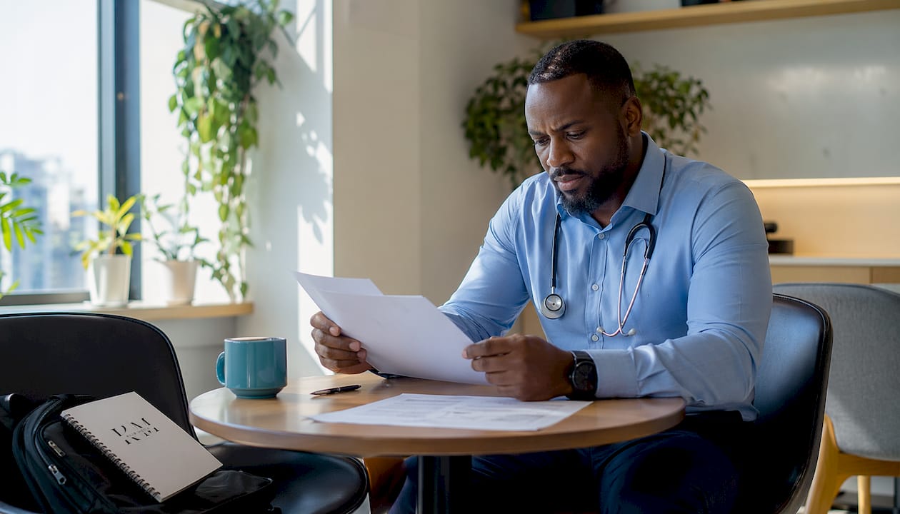 Physician thoughtfully reviewing patient information