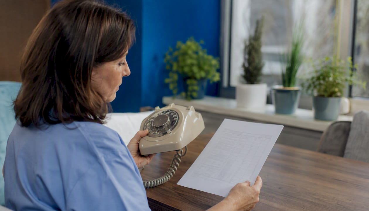 Hands holding phone handset timing call